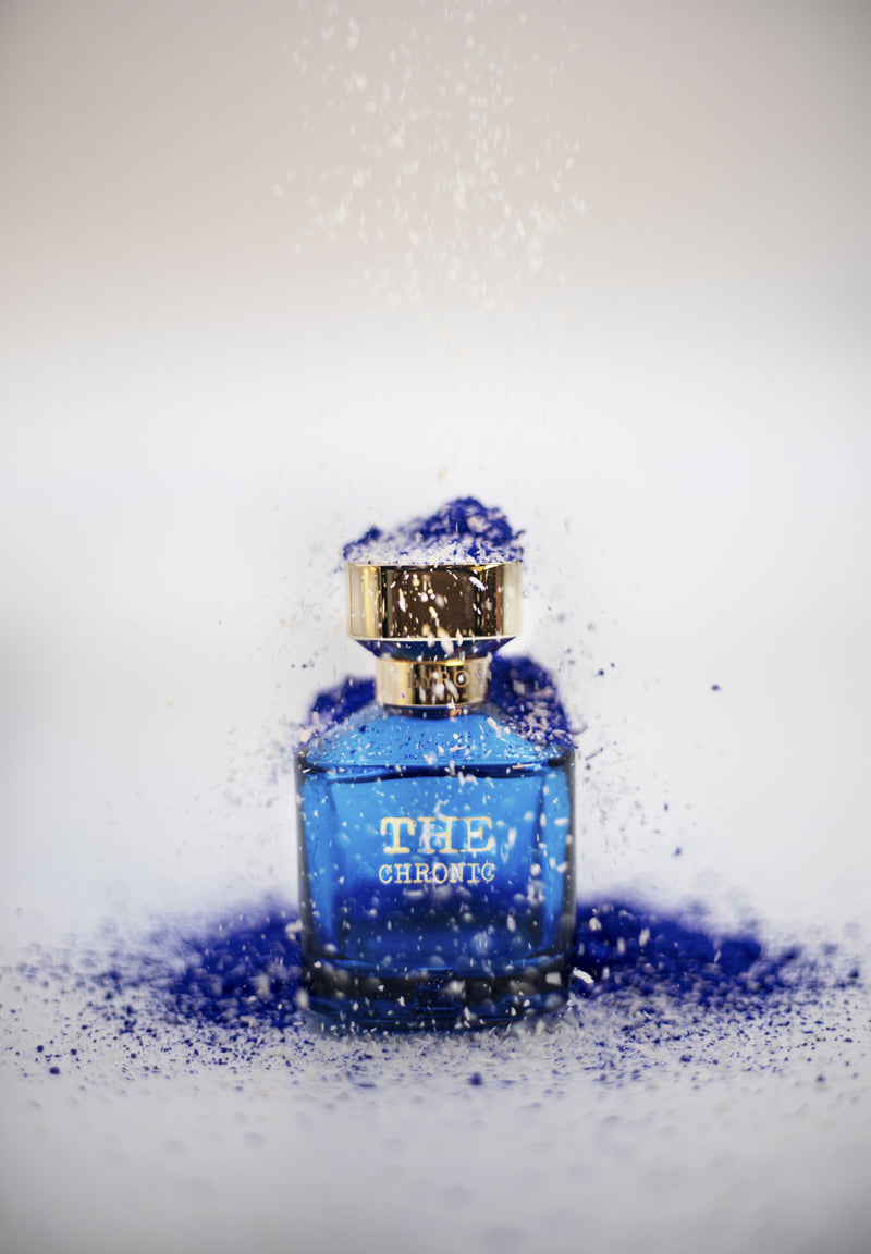 Load image into Gallery viewer, A Byron Parfums&#39; The Chronic Narcotic Collection 75ml Extrait De Parfum blue perfume bottle with a hint of blue powder on top, exuding a mesmerizing fragrance.
