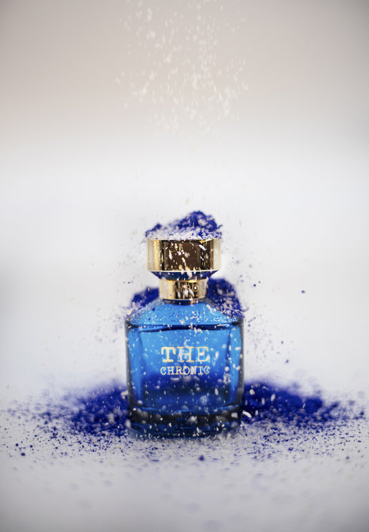 A Byron Parfums' The Chronic Narcotic Collection 75ml Extrait De Parfum blue perfume bottle with a hint of blue powder on top, exuding a mesmerizing fragrance.