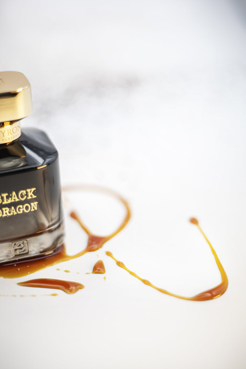 Load image into Gallery viewer, A bottle of Byron Parfums Black Dragon 75ml Extrait De Parfum confidently rests on a clean white surface, exuding an irresistible aura of luxury and power.

