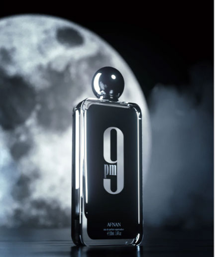 Load image into Gallery viewer, A bottle of Afnan 9 pm Eau De Parfum with the number 9 in front of a full moon, available at Rio Perfumes.
