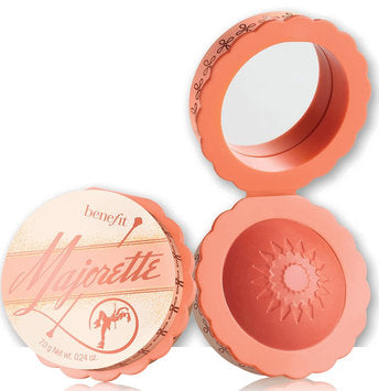 The Benefit Majorette Blush is a stunning pink-peach shade that acts as a booster blush, enhancing the natural glow of your cheeks.