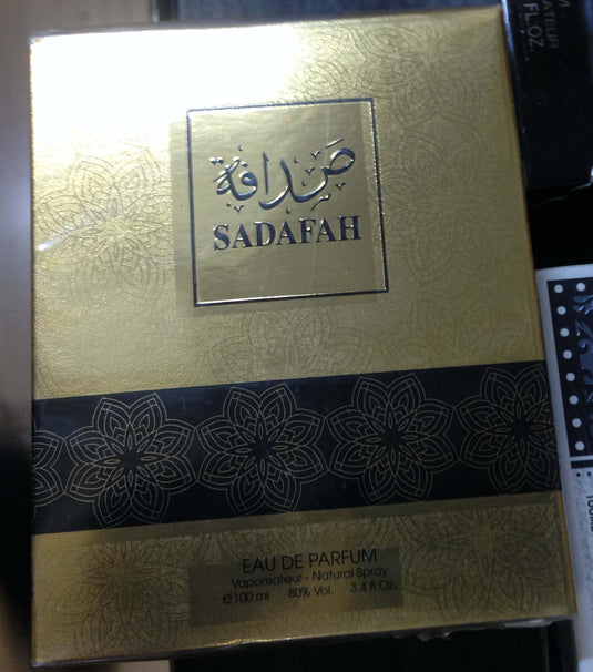 A box of Sadafah 100ml Eau De Parfum by Dubai Perfumes, known for its fragrant essence, delicately placed on a table.