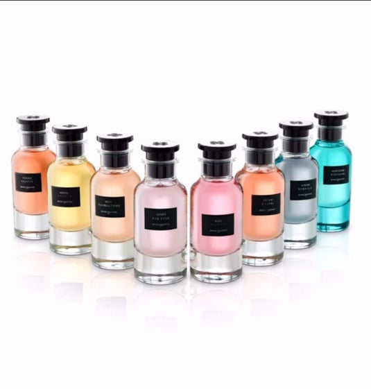 A collection of Reyane Tradition Oud Black Imperial 85ml EDP perfume bottles in various captivating colors, showcased elegantly against a pristine white backdrop.