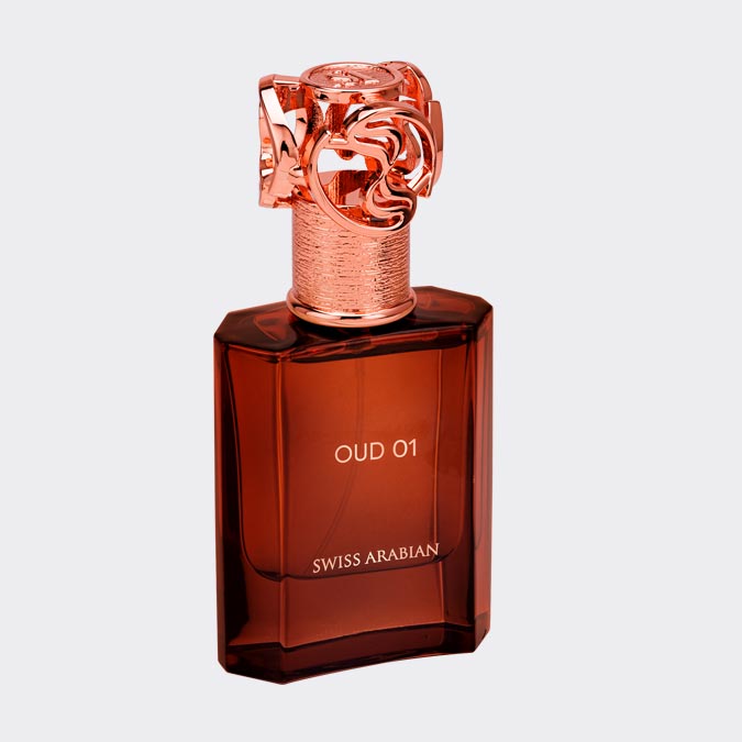 Load image into Gallery viewer, A bottle of Swiss Arabian Oud 01 50ml Eau De Parfum with a rose on it.
