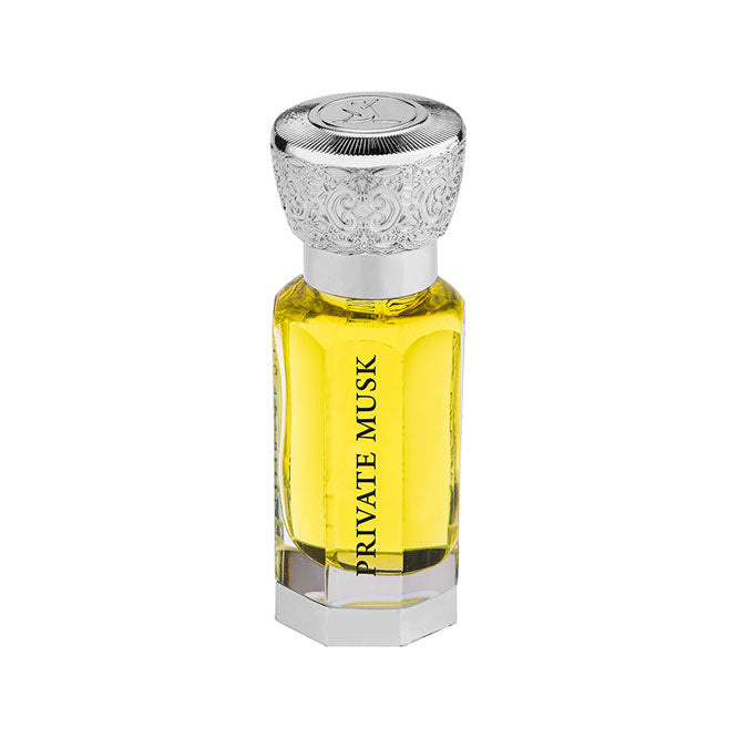 Load image into Gallery viewer, A bottle of Guess Swiss Arabian Private Musk 12ml Concentrated Perfume Oil with a silver lid.
