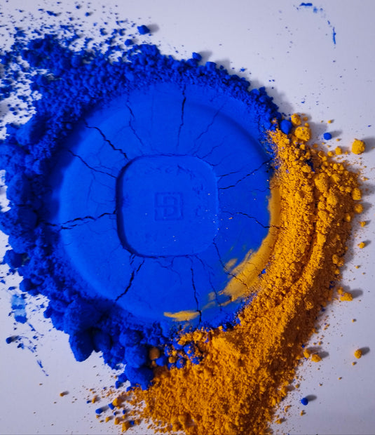 A blue and yellow Byron Parfums Mula Mula 75ml Extrait De Parfum Narcotic Collection powder on a white surface.