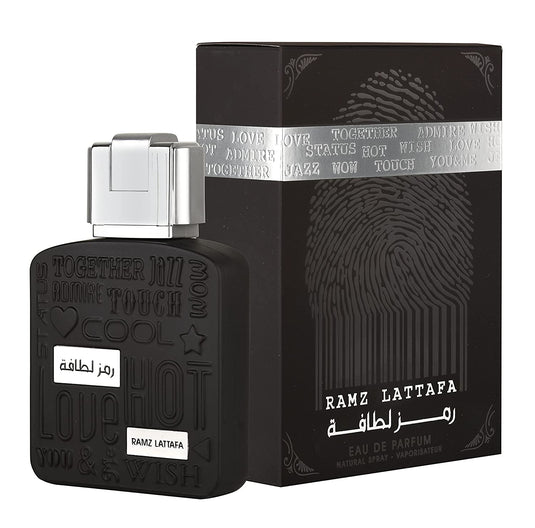 A bottle of Lattafa Ramz Silver 100ml Eau de Parfum with a box in front of it.