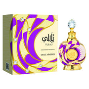 A decorative bottle of Swiss Arabian Yulali Concentrated Perfume Oil, a vibrant unisex scent from Swiss Arabian, is shown next to its matching gold, purple, and white packaging.