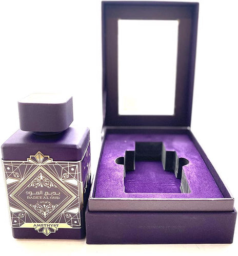 A bottle of Lattafa Badee Al Oud Amethyst 100ml Eau De Parfum in a purple box.