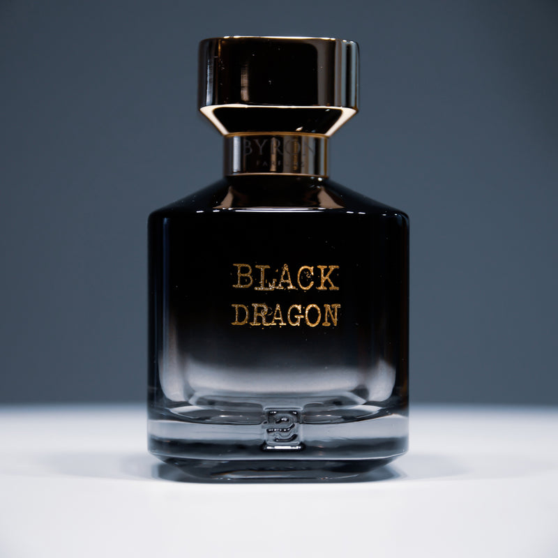 Load image into Gallery viewer, A bottle of Byron Parfums Black Dragon 75ml Extrait De Parfum, from the brand Byron Parfums, placed elegantly on a table.

