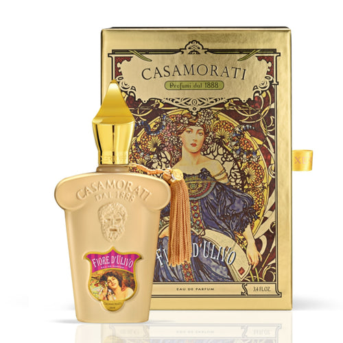 A bottle of Xerjoff Casamorati Fiore d'Ulivo 100ml EDP fragrance in front of a gold box.