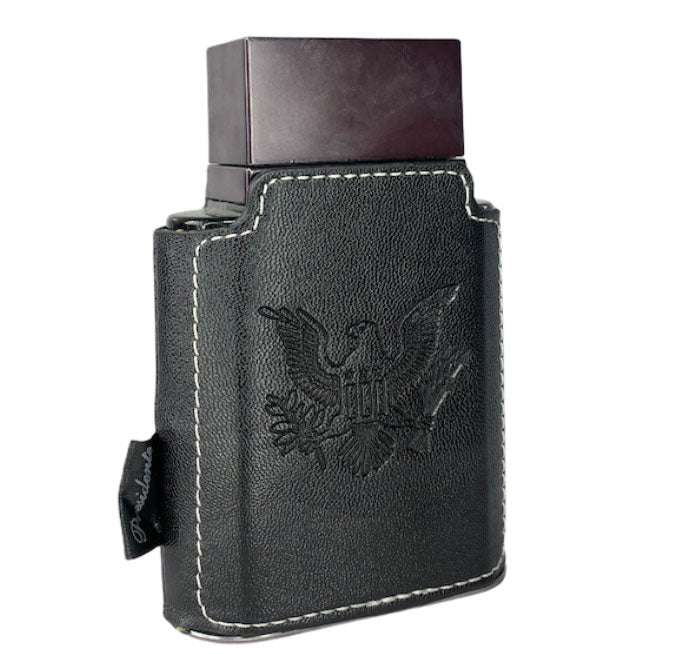 A sleek black rectangular case with white stitching and an embossed eagle emblem contains a dark bottle inside—an elegant presentation for Emper Presidente Pour Homme 100ml Eau De Parfum by Emper, a sophisticated fragrance for men.