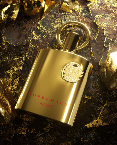 A Rio Perfumes Afnan Supremacy Gold 100ml Eau De Parfum bottle adorned with gold and diamonds.