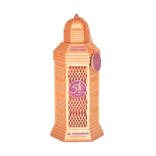 An Al Haramain orange lantern with a tag on it, filled with the exquisite aroma of Al Haramain 50 Years Rose Oud Spray 100ml Eau De Parfum.