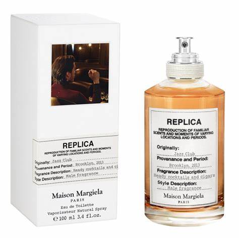 A bottle of Maison Martin Margiela Replica Jazz Club cologne next to a box.