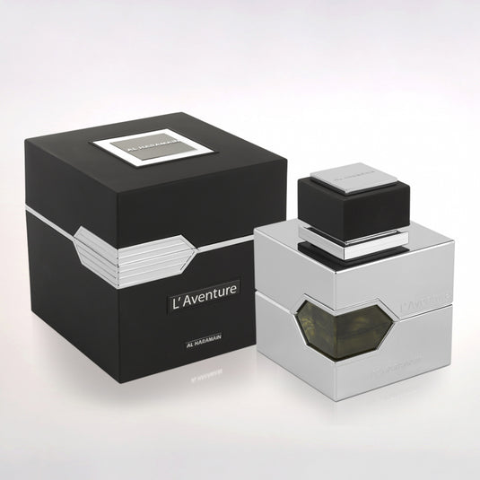 A bottle of Al Haramain L'Aventure Intense 100ml perfume with a black box next to it.