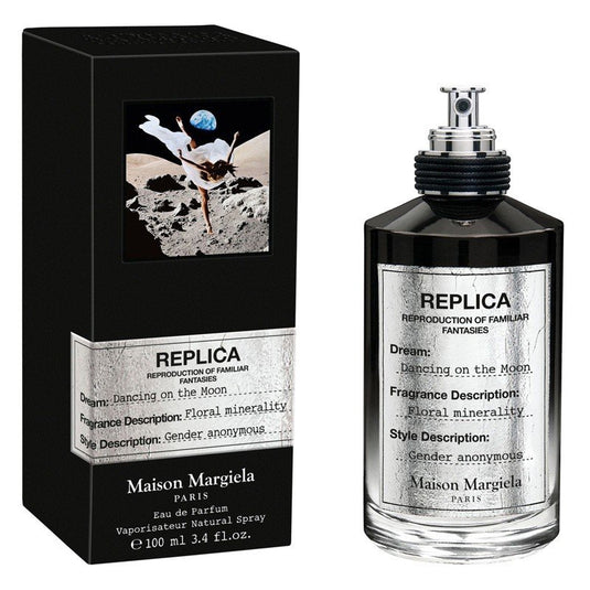 A bottle of Maison Martin Margiela Replica Dancing On The Moon 100ml Eau De Parfum with a box next to it.