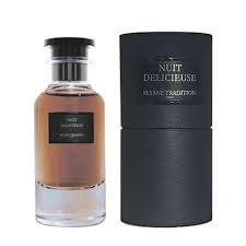 A bottle of Reyane Tradition Nuit Delicieuse 85ml EDP perfume with a black box next to it.