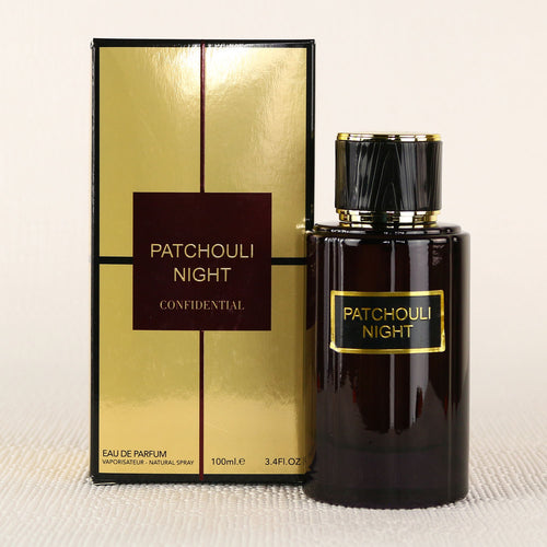 A fragrance bottle of Patchouli Night 100ml Eau De Parfum by Dubai Perfumes on a table next to a box.