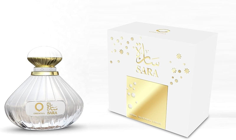 Load image into Gallery viewer, A women&#39;s fragrance bottle of Orientica Sara 100ml Eau De Parfum by Dubai Perfumes with a box next to it.
