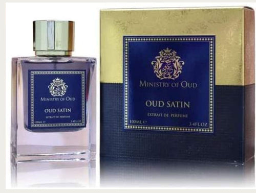 A bottle of Paris Corner Ministry of Oud Oud Satin 100ml Extrait de Perfume, embellished with the rich fragrance of oud satin, stands elegantly in front of a box.