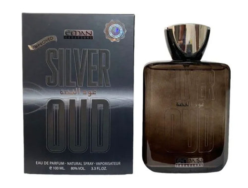 A bottle of Eman Creations Silver Oud 100ml Eau de Parfum by Dubai Perfumes next to a box.
